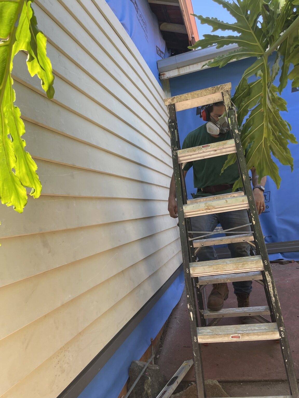 HandMate carrying out exterior preparation work with respiratory and hearing protection